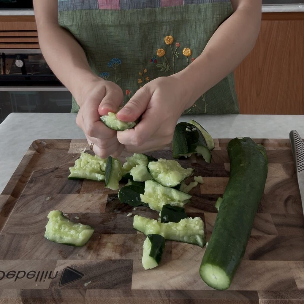 Smashed Cucumber Salad Finishing smashing cucumbers by hand for Korean smashed cucumber salad