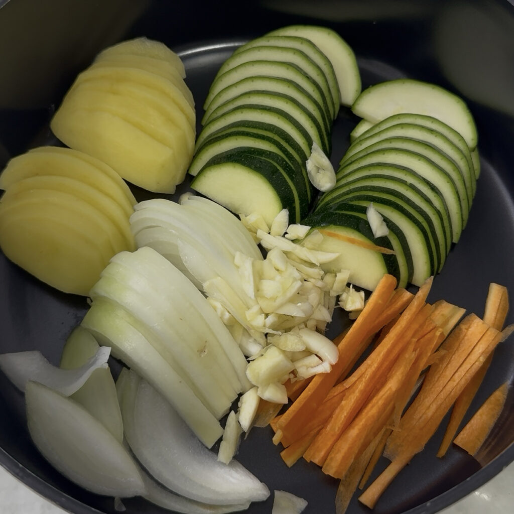 Sujebi All vegetables added to a pot for Korean sujebi soup broth