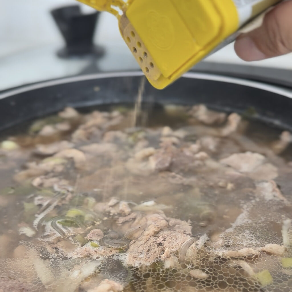 Sprinkling black pepper over Galbitang