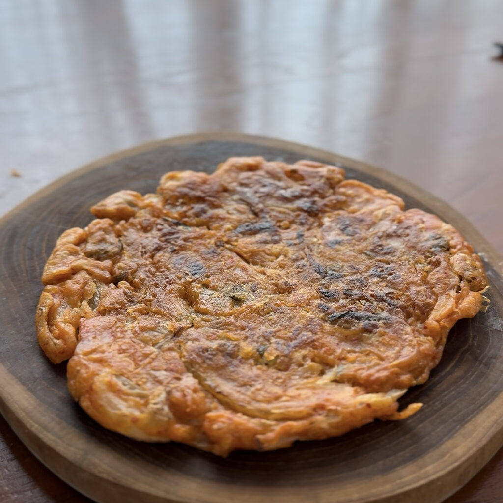 Close-up of crispy kimchi pancakes with a golden brown texture