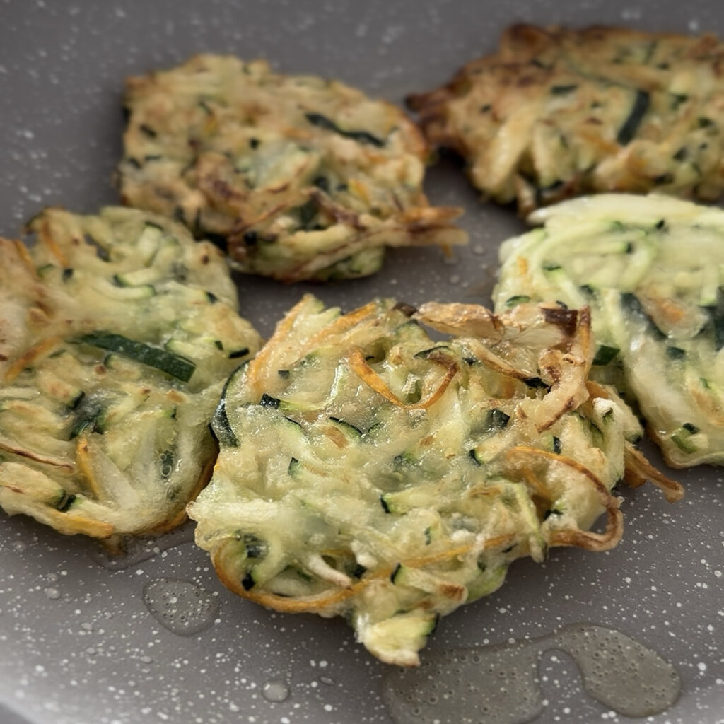 Golden brown Korean zucchini pancake with a light, crispy texture and fresh vegetables.