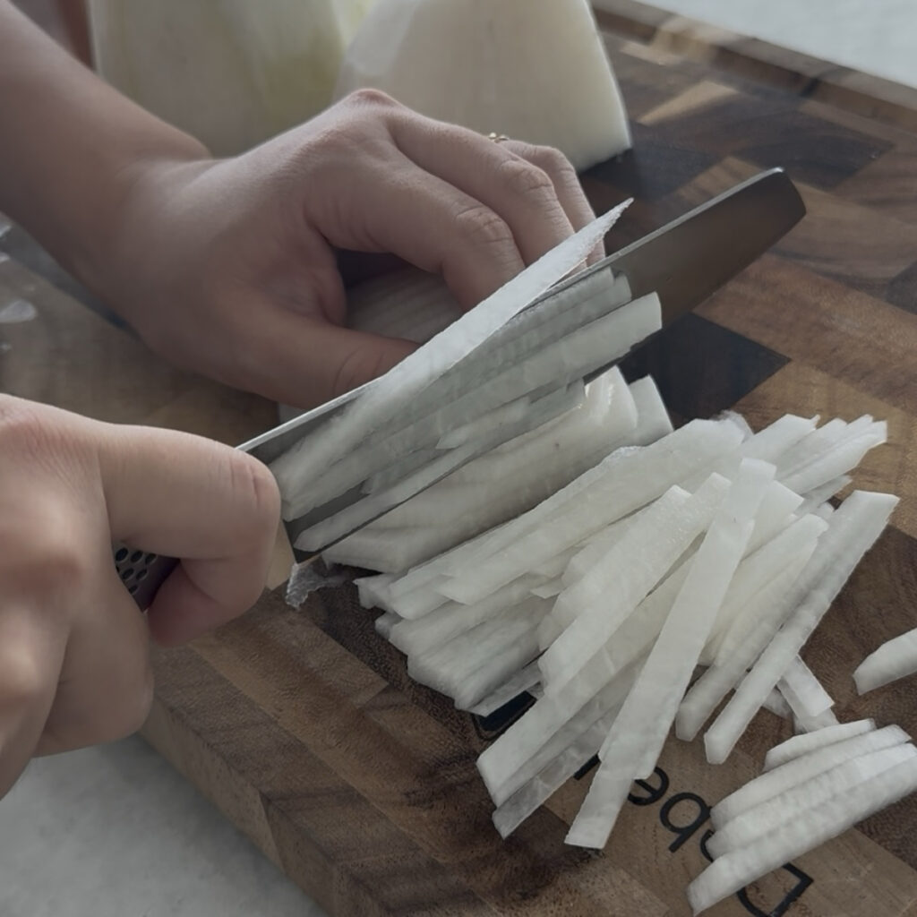 Freshly julienned daikon radish for Korean spicy radish salad.
