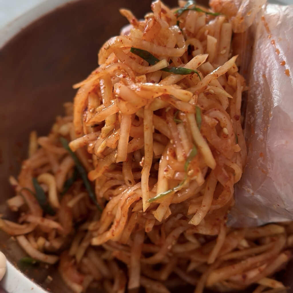 Homemade Korean Spicy Radish Salad (Musaengchae), a crunchy Korean side dish made with fresh daikon radish.