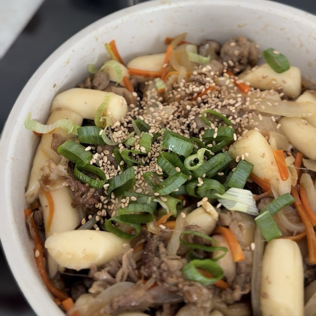 Finishing Gungjung Tteokbokki with sesame oil