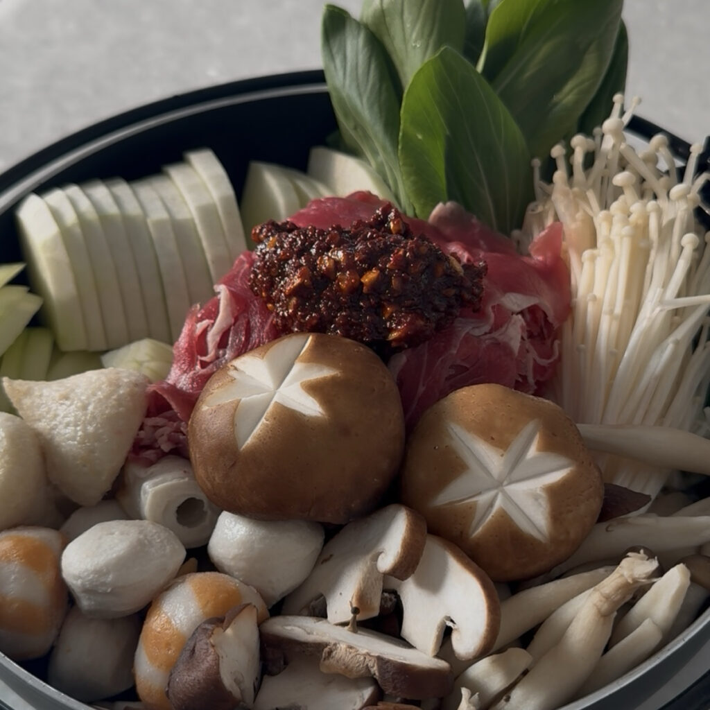 Homemade Korean spicy seasoning paste added to the hot pot ingredients.