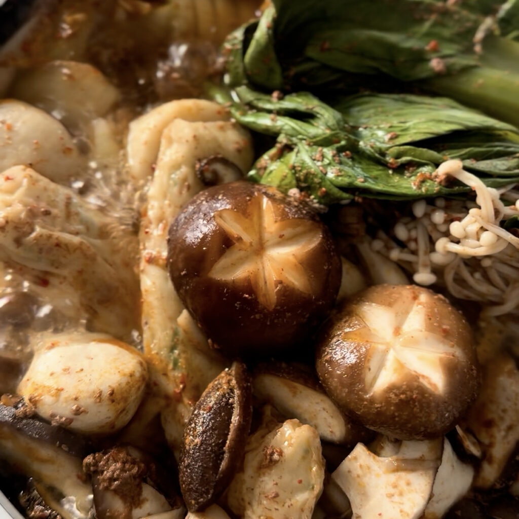 Spicy Korean Shabu Shabu with beef, mushrooms, bok choy, and a rich homemade broth.