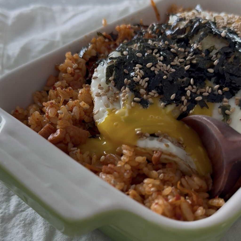 Spam kimchi fried rice topped with a fried egg with a runny yolk