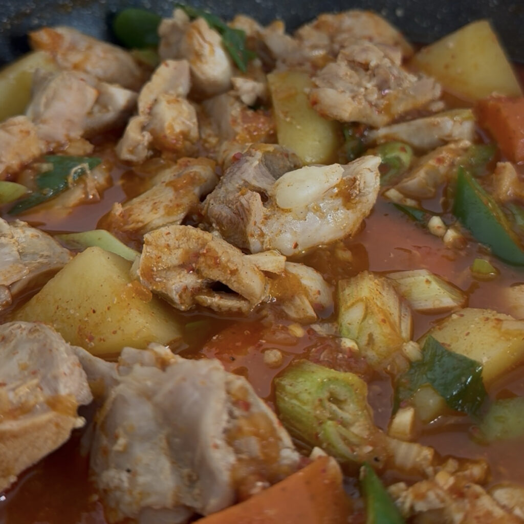 Homemade Dakbokkeumtang served with tender chicken and sauce-soaked potatoes.