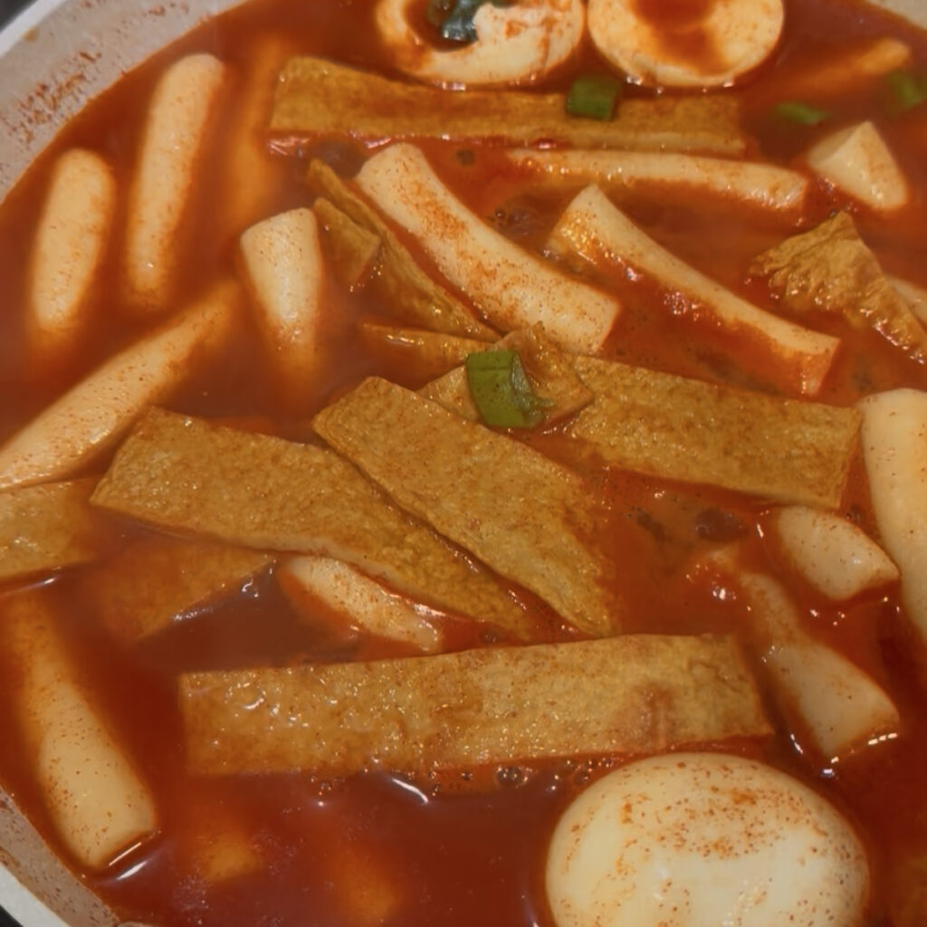 Spicy tteokbokki sauce simmering in a pan