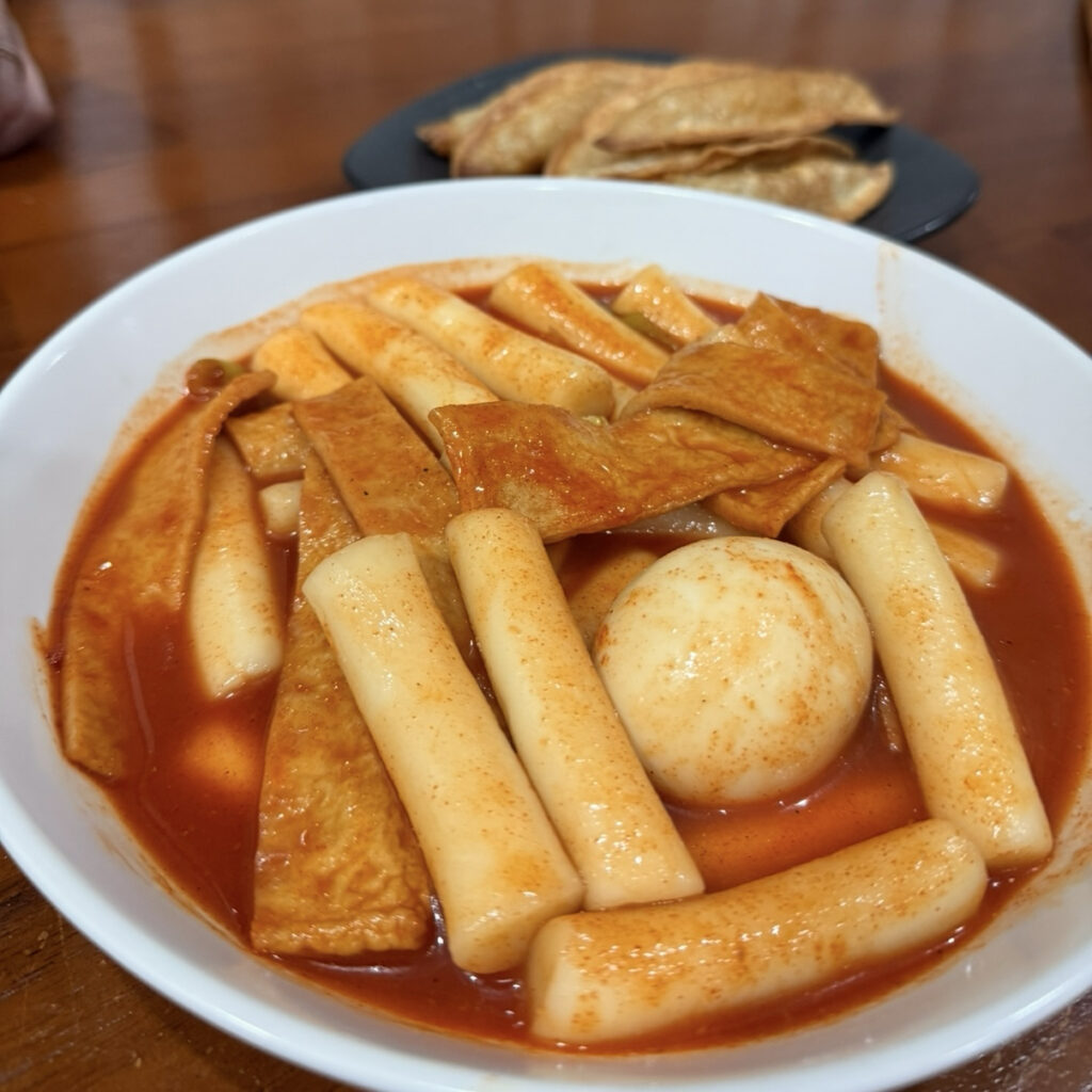 Korean tteokbokki with chewy rice cakes and fish cakes in spicy red sauce