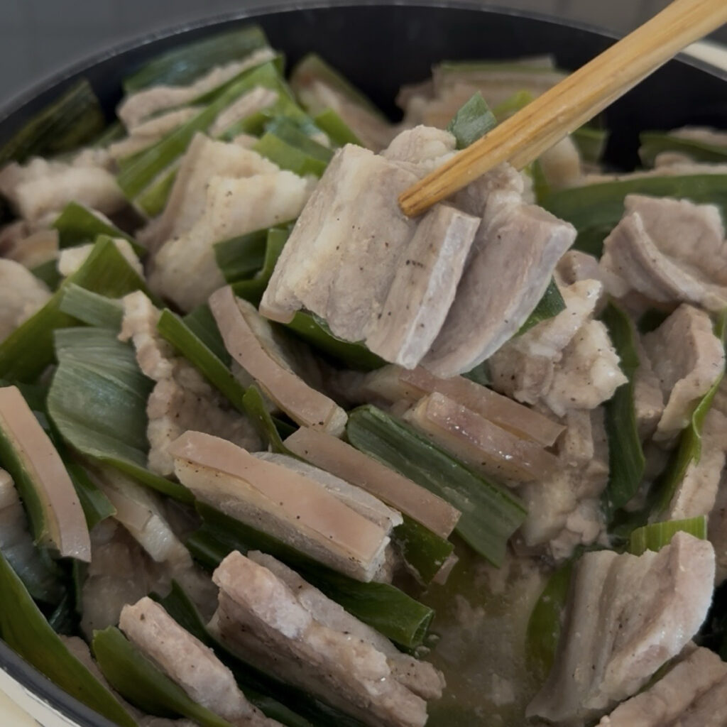 Korean pork belly and cooked green onions served as a Korean-style meal