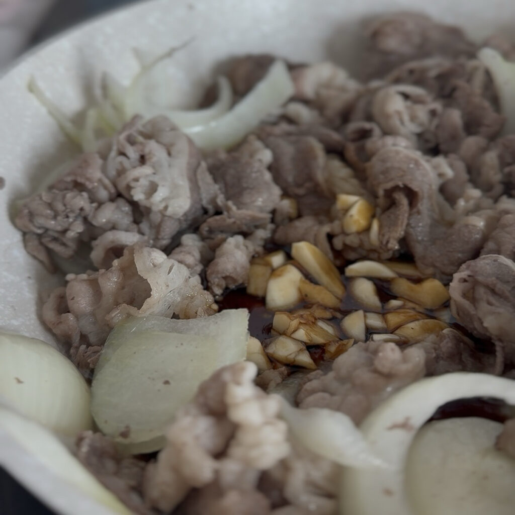 Tossing the beef and onions with the seasoning