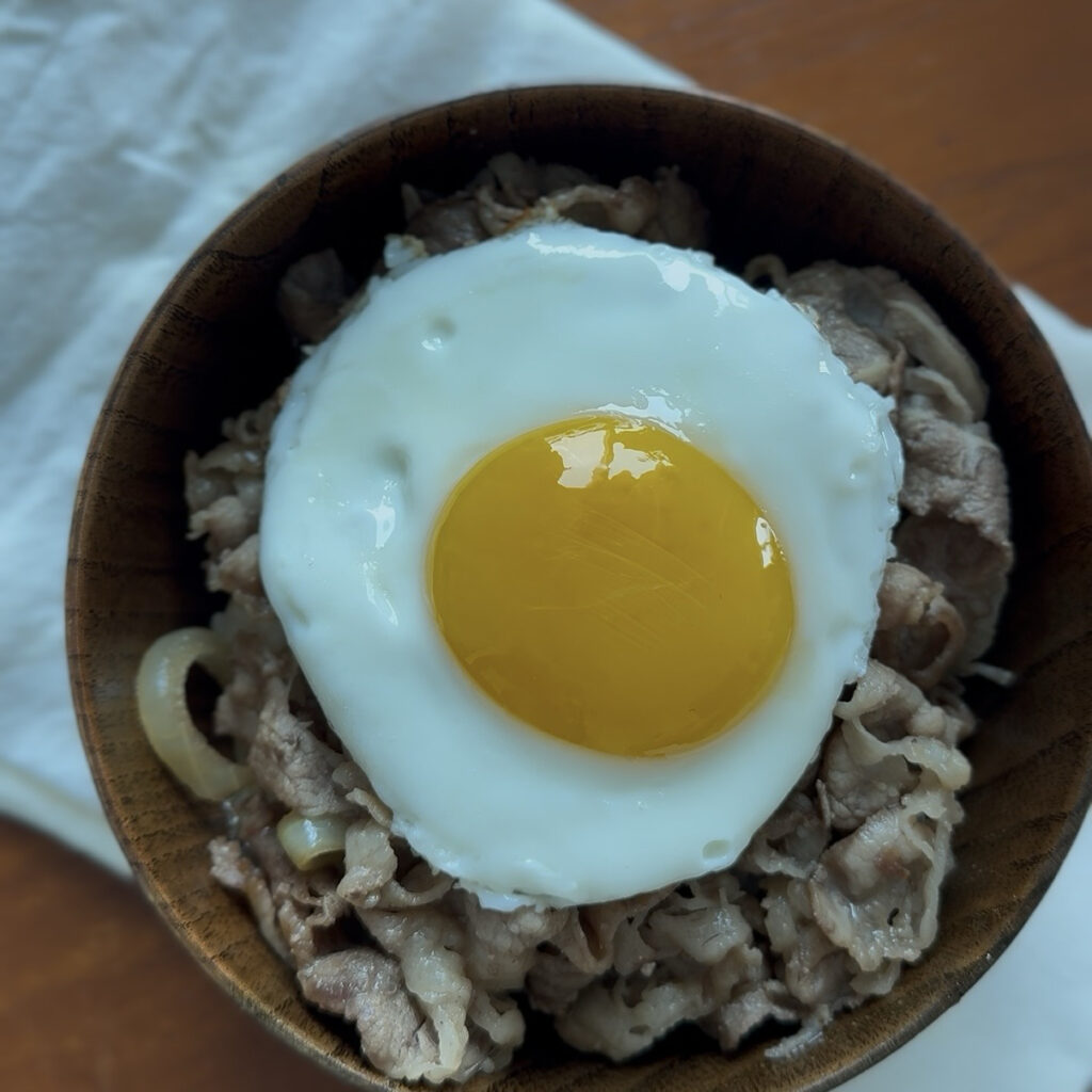 Savory Korean beef belly rice bowl with a runny egg yolk