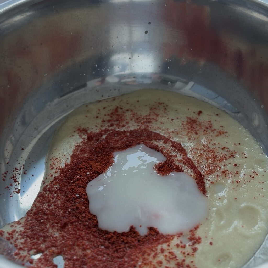 Mixing gochugaru and flour paste into the kimchi seasoning
