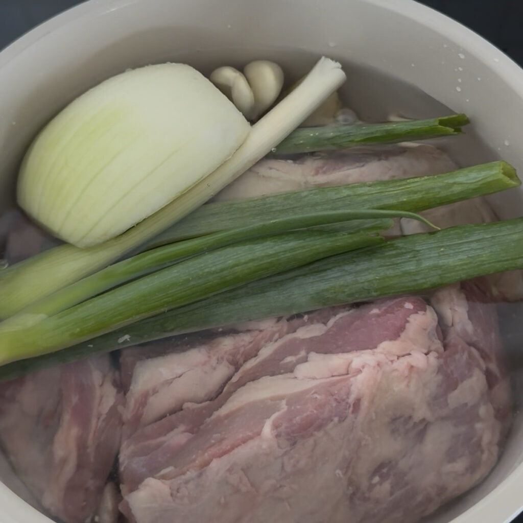 Beef and aromatics in a pot before boiling